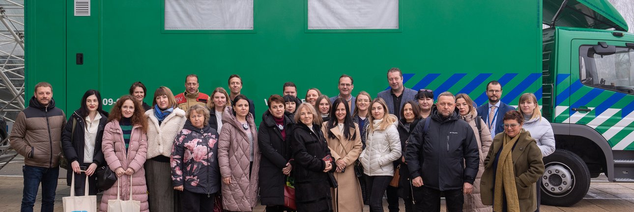 Groep mensen voor de MCU op het terrein van provinciehuis