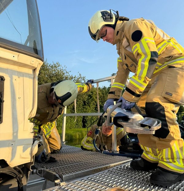 Brandweerman met materiaal aan het werk